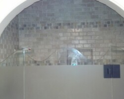 waved pattern at the top with sandblasted door and panels on 1/2" European frameless shower door system